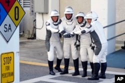 SpaceX Crew5 astronauts, from left, Anna Kikina of Russia, Josh Cassada, Nicole Mann, and Koichi Wakata of Japan, pose for a photo at the Kennedy Space Center in Cape Canaveral, Fla., Oct. 5, 2022.