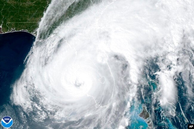 This satellite image taken at 3:06 p.m. EDT and provided by NOAA shows Hurricane Ian making landfall in southwest Florida near Cayo Costa, Florida, on Sept. 28, 2022, as a catastrophic Category 4 storm.