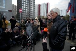 Oleg Orlov, a member of the Board of the International Historical Educational Charitable and Human Rights Society 'Memorial' (International Memorial), right, and Jan Rachinsky, Chairman of the Board of the International "Memorial", speak to media after a after a court hearing in Moscow, Russia, Friday, Oct. 7, 2022. (AP Photo/Alexander Zemlianichenko)