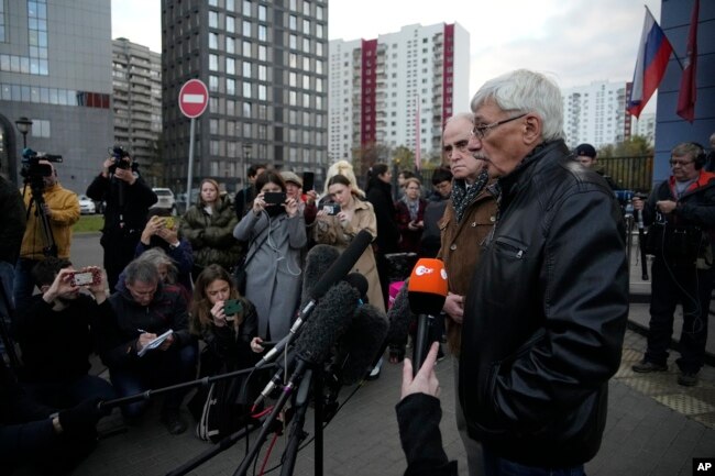 Oleg Orlov, a member of the Board of the International Historical Educational Charitable and Human Rights Society 'Memorial' (International Memorial), right, and Jan Rachinsky, Chairman of the Board of the International "Memorial", speak to media after a after a court hearing in Moscow, Russia, Friday, Oct. 7, 2022. (AP Photo/Alexander Zemlianichenko)