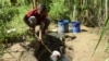 FILE - A boy fetches water from a borehole for domestic use at Mbopo ward, where there is no access to a public water supply, in Dar es Salaam, Tanzania, March 21, 2020. Rains have been short in East Africa since late 2020.