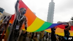 Participants revel through a street during the annual Taiwan LGBTQ+ Pride parade in Taipei, Taiwan, Oct. 29, 2022. 