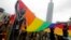 Participants revel through a street during the annual Taiwan LGBTQ+ Pride parade in Taipei, Taiwan, Oct. 29, 2022. 