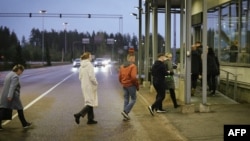 People entering Finland reach the passport control area at the border crossing in Vaalimaa, Finland, on the border with the Russian Federation on Sept. 29, 2022. Finland will bar Russians with Schengen tourist visas from entering the country beginning Sept. 30.