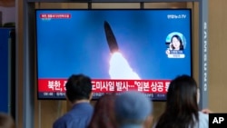 A TV screen showing a news program reporting about North Korea's missile launch with file footage, is seen at the Seoul Railway Station in Seoul, South Korea, Oct. 4, 2022