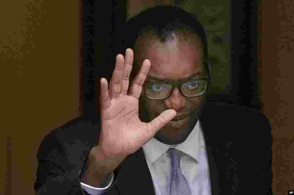 Britain's former Chancellor of the Exchequer Kwasi Kwarteng waves to the media as he leaves 11 Downing Street after being sacked by the Prime Minister Liz Truss in London.