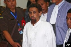 FILE - Indonesian Muslim militant Hisyam bin Alizein, center, better known by his alias Umar Patek, the bombmaker of a 2002 Bali bombing. (AP Photo/Tatan Syuflana, File)