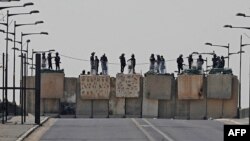 Iraqi security forces block a road leading to the Green Zone in Baghdad, Oct. 13, 2022 as lawmakers gather for their fourth attempt this year to elect a new state president and break political gridlock that has sparked deadly violence.
