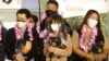 A group of foreign travelers hold souvenirs after arriving at Taoyuan International Airport in Taoyuan, Northern Taiwan, Oct. 13, 2022. 