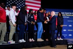 President Joe Biden greets Delaware State University students after speaking about student loan debt relief at the university, Oct. 21, 2022, in Dover, Del.