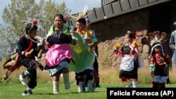 Hopi children dance in front of City Hall on Indigenous Peoples Day in Flagstaff, Ariz., Monday, Oct. 10, 2022.