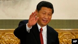 FILE - Xi Jinping waves in Beijing's Great Hall of the People on Nov. 15, 2012. 