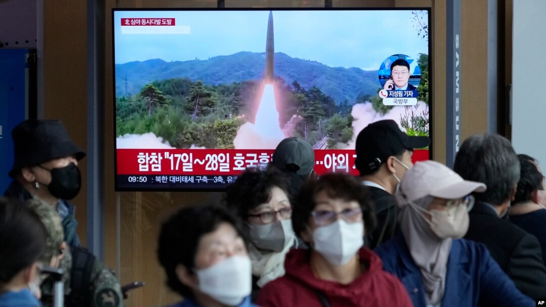 FILE - A TV screen shows a file image of North Korea's missile launch during a news program at the Seoul Railway Station in Seoul, South Korea on Oct. 14, 2022. North and South Korea say they exchanged warning shots early Monday, Oct. 24, 2022, local time.