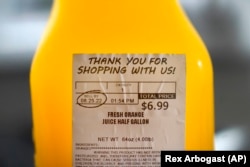 A "SELL BY" date is circled on a half gallon of fresh squeezed orange juice, Sunday, Aug. 21, 2022, in Chicago. (AP Photo/Charles Rex Arbogast)