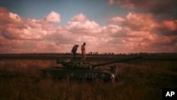 Ukrainian servicemen stand on top a Ukrainian tank near the recently retaken village of Borova, east Ukraine, Oct. 7, 2022.