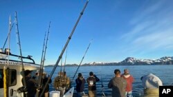 Participants, members of the armed services, and crews of the annual ASYMCA Alaska Combat Fishing Tournament are seen on May 25, 2022, in Seward, Alaska. The tournament, which began in 2007 and now involves more than 300 soldiers, includes a day of deep-w