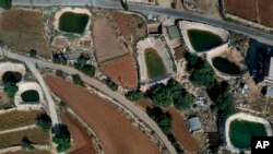 Innovative artificial ponds are seen between agricultural fields at Harf Beit Hasna village, in Dinnieh province, north Lebanon, Sept. 7, 2022.