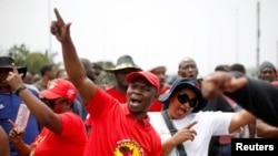 Transnet workers protest as a labor strike continues at an entrance to the harbor in Durban, South Africa, Oct. 17, 2022. 