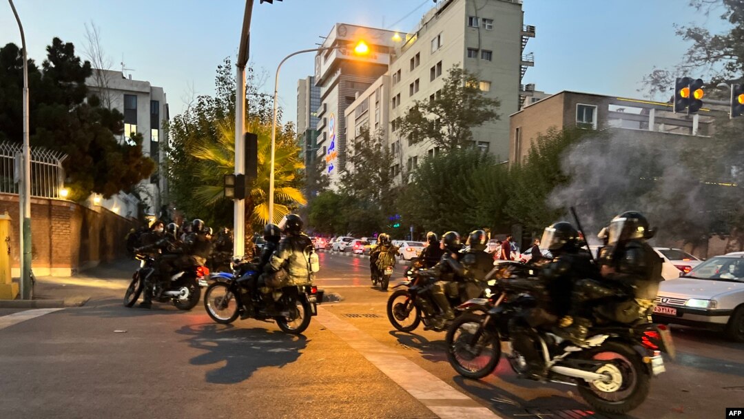 FILE - A picture obtained by AFP outside Iran shows shows Iranian police on motorbikes during a protest in support of Mahsa Amini, a woman who died after being arrested by the Islamic republic's "morality police", in Tehran on Sept. 19, 2022.
