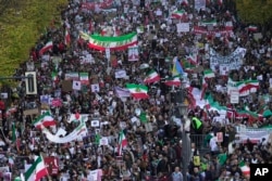 People attend a protest against the Iranian regime, in Berlin, Germany, Oct. 22, 2022, following the death of Mahsa Amini in the custody of the Islamic republic's notorious "morality police."