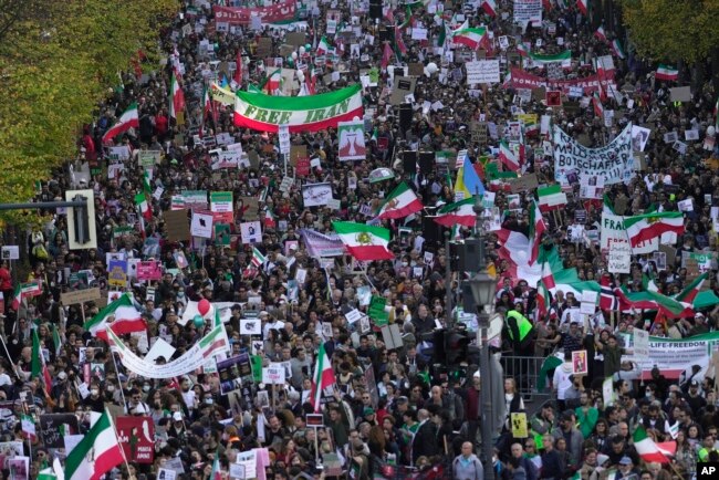People attend a protest against the Iranian regime, in Berlin, Germany, Oct. 22, 2022, following the death of Mahsa Amini in the custody of the Islamic republic's notorious "morality police."