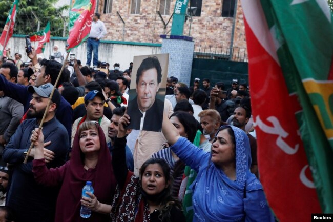 Supporters of the Pakistan Tehreek-e-Insaf (PTI) political party chant slogans as they gather, after Pakistan Election Commission disqualifies former Prime Minister Imran Khan on charges of unlawfully selling state gifts, during a protest in Karachi, Pakistan, Oct. 21, 2022.