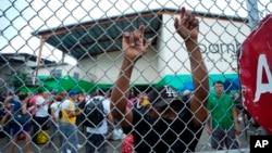 Un migrante venezolano se apoya en una cerca en un almacén comercial que se utiliza como refugio temporal en la Ciudad de Panamá, el martes 25 de octubre de 2022. (Foto AP/Arnulfo Franco)