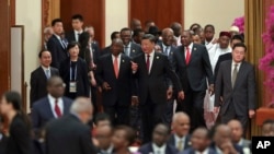 FILE - Chinese President Xi Jinping, center, with South African President Cyril Ramaphosa, center left, attends the 2018 Beijing Summit Of The Forum On China-Africa Cooperation-Round Table Conference at at the Great Hall of the People in Beijing, Sept. 4, 2018.