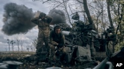 Ukrainian soldiers fire at Russian positions from a U.S.-supplied M777 howitzer in Ukraine's eastern Donetsk region, Oct. 23, 2022.
