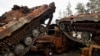 FILE - Destroyed Russian tanks and armored vehicles from Russia's invasion of Ukraine are seen stacked up in the liberated town of Lyman, Donetsk region, Ukraine, Oct. 5, 2022. 