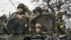 Ukrainian soldiers ride an APC in Donetsk region, Ukraine, Oct. 20, 2022.