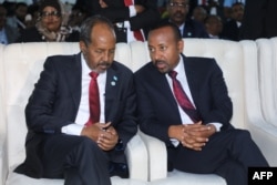 FILE - Somali President Hassan Sheikh Mohamud, left, speaks with Ethiopia's Prime Minister Abiy Ahmed, in Mogadishu, Somalia, June 9, 2022.