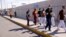 FILE - Cuban migrants who were expelled from the U.S. and sent back to Mexico under Title 42 walk near the at the Lerdo Stanton International border bridge, in Ciudad Juarez, Mexico, May 3, 2022.