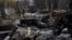 FILE - Ukrainian soldiers walk amid destroyed Russian tanks in Bucha, on the outskirts of Kyiv, Ukraine, April 3, 2022.