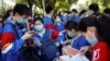 FILE - Students prepare to take part in the annual national college entrance exam outside a high school in Beijing, China July 7, 2020.