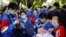 FILE - Students prepare to take part in the annual national college entrance exam outside a high school in Beijing, China July 7, 2020.