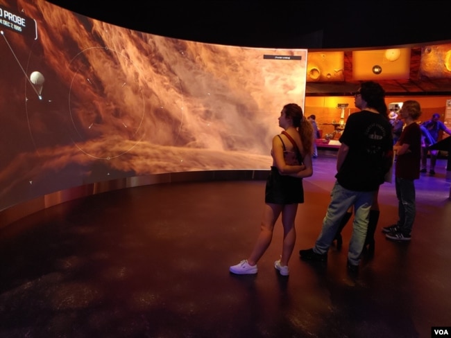 In the planets gallery, visitors take an immersive trip through the solar system to get a close-up look at the surface of planets and asteroids on a large scale. (Deborah Block/VOA)