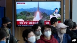  FILE - A TV screen shows a file image of North Korea's missile launch during a news program at the Seoul Railway Station in Seoul, South Korea on Oct. 14, 2022. 