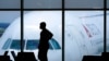 FILE - A passenger waits for a flight at Hartsfield-Jackson International Airport in Atlanta, Feb. 18, 2021. The airport was among those that experienced website issues Oct. 10, 2022, in an apparent coordinated denial-of-service attack. Officials said flights were not affected.