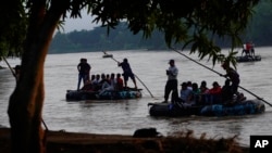 Venezuelan migrants cross the Suchiate river, the border between Guatemala and Mexico, near Ciudad Hidalgo, Chiapas state, Mexico, Oct. 4, 2022.