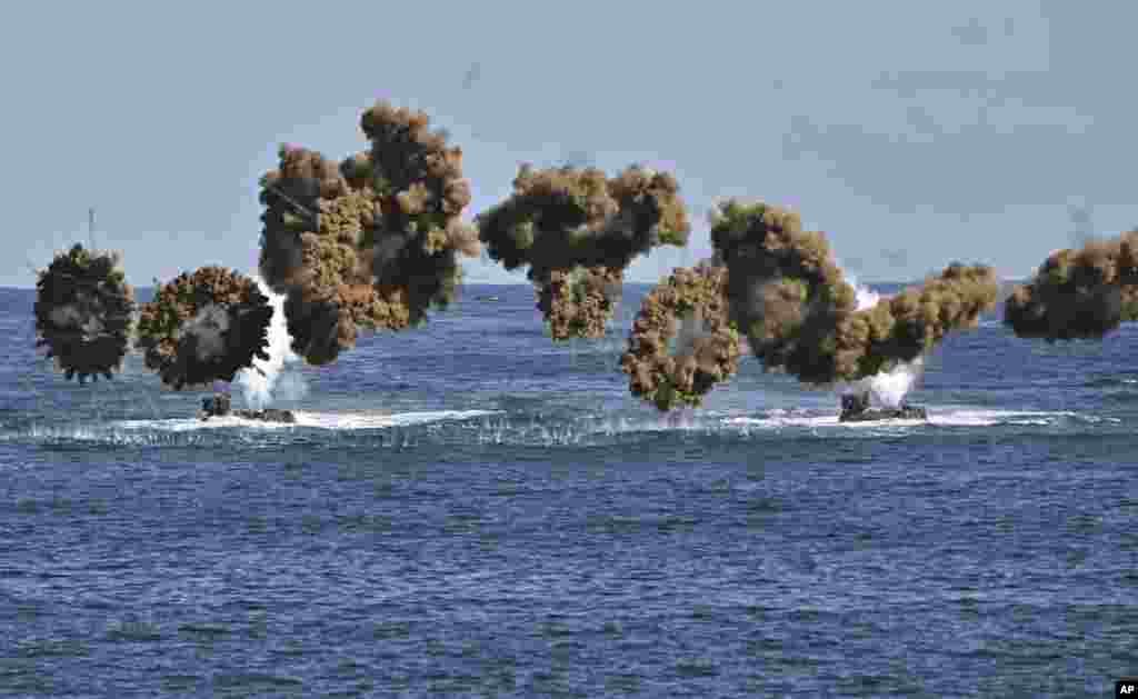 South Korean Marine amphibious assault vehicles fire smoke shells to land on the seashore during a landing operation as part of the annual Hoguk military exercise in Pohang.