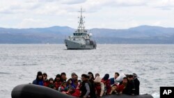 FILE: Representative illustration of migrants in a rubber boat in the Mediterranean Sea awaiting pickup by a EU "rescue vessel." Taken Feb. 28, 2020