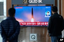 FILE - A TV screen showing a news program reporting about North Korea's missile launch with file image, is seen at the Seoul Railway Station in Seoul, South Korea, Oct. 4, 2022.