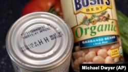 An expired "best by" date is seen on a can of garbanzo beans, Saturday, Aug. 20, 2022, in Boston, Massachusetts. (AP Photo/Michael Dwyer)