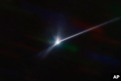 This image made available by NOIRLab shows a plume of dust and debris blasted from the surface of the asteroid Dimorphos by NASA's DART spacecraft after it impacted on Sept. 26, 2022. The expanding, comet-like tail is more than 10,000 kilometers long. (Teddy Kareta, Matthew Knight/NOIRLab via AP)