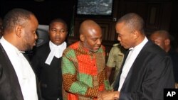FILE: Biafran separatist leader Nnamdi Kanu, center, speaks to his lawyers at the Federal High court in Abuja, Nigeria on Friday, Jan. 29, 2016.