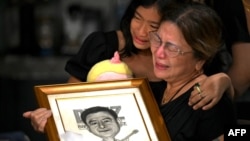 Family members grieve the loss of journalist Percival Mabasa at their home in Las Pinas, suburban Manila, Oct. 4, 2022.