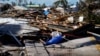 Responders from the de Moya Group survey damage to the bridge leading to Pine Island, to start building temporary access to the island in the aftermath of Hurricane Ian in Matlacha, Florida, Oct. 2, 2022. 