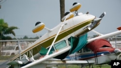 An airplane overturned by a likely tornado produced by the outer bands of Hurricane Ian is shown, Sept. 28, 2022, at North Perry Airport in Pembroke Pines, Fla.