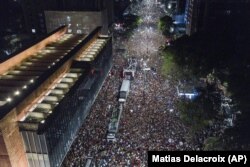 Supporters of former Brazilian President Luiz Inacio Lula gather after he defeated Jair Bolsonaro in a presidential election in Sao Paulo, Brazil, Sunday, Oct. 30, 2022. (AP Photo/Matias Delacroix)